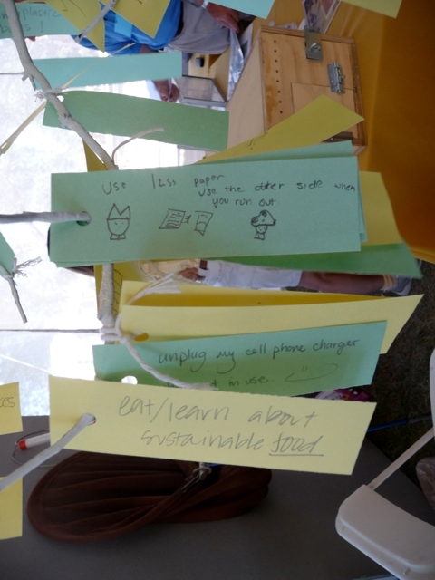 Visitors leave suggestions for sustainable actions at the Smithsonian and in their own lives on a Sustainability Tree in the Tending and Mending tent of the Smithsonian Inside Out program.
