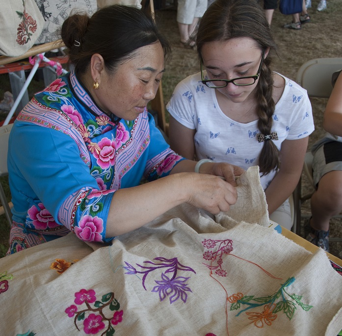 Li Xingxiu demonstrates her craft to a Festival visitor. Photo by Michelle Albeit, Ralph Rinzler Folklife Archives