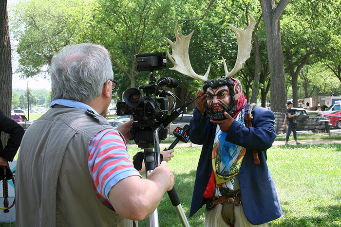 A film crew from Voice of America interviewed a member of Grupo Nuu Yuku in between devil dances. Photo by Elisa Hough, Ralph Rinzler Folklife Archives