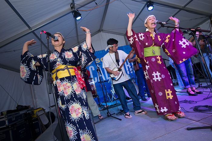 <em>FandangObon</em> gave their last Folklife Festival performances today, with Nancy Sekizawa and Nobuko Miyamoto leading the singing and dancing. Tomorrow they head back to Los Angeles. Photo by Walter Larrimore, Ralph Rinzler Folklife Archives