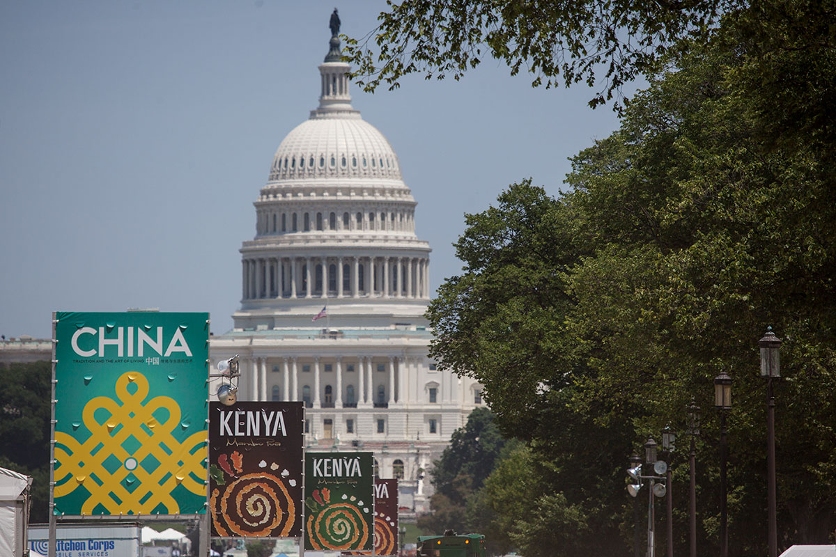 The U.S. Capitol building in the distance, with event banners reading KENYA and CHINA in the foreground.