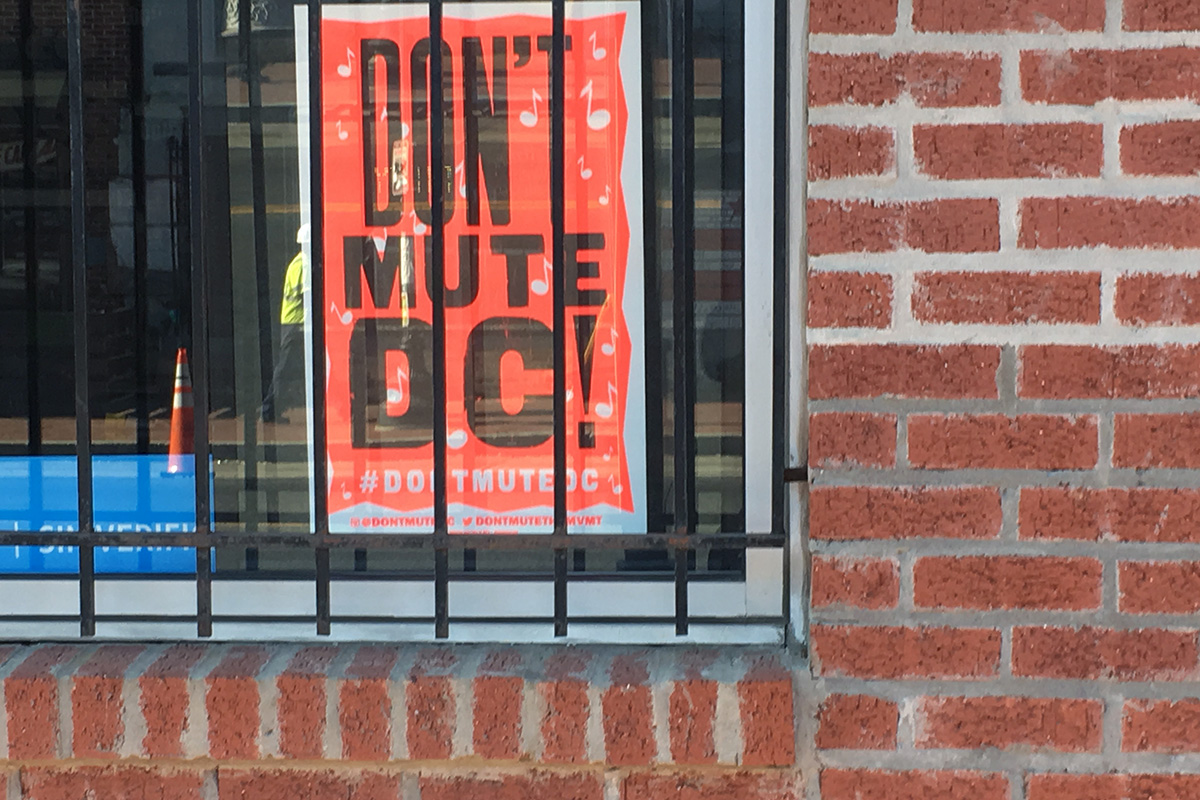 Globe Poster in the window of Central Communications (Metro PCS), ground zero of the Don’t Mute DC movement.