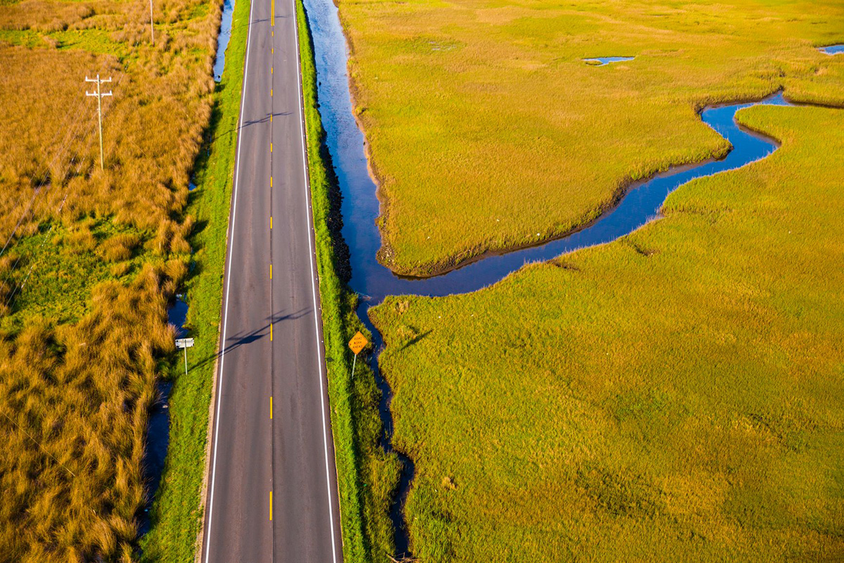 “Road Work Ahead” shows the North River bridge approach, the gateway to Down East Carteret County, North Carolina. Photo by Baxter Miller, RisingNC