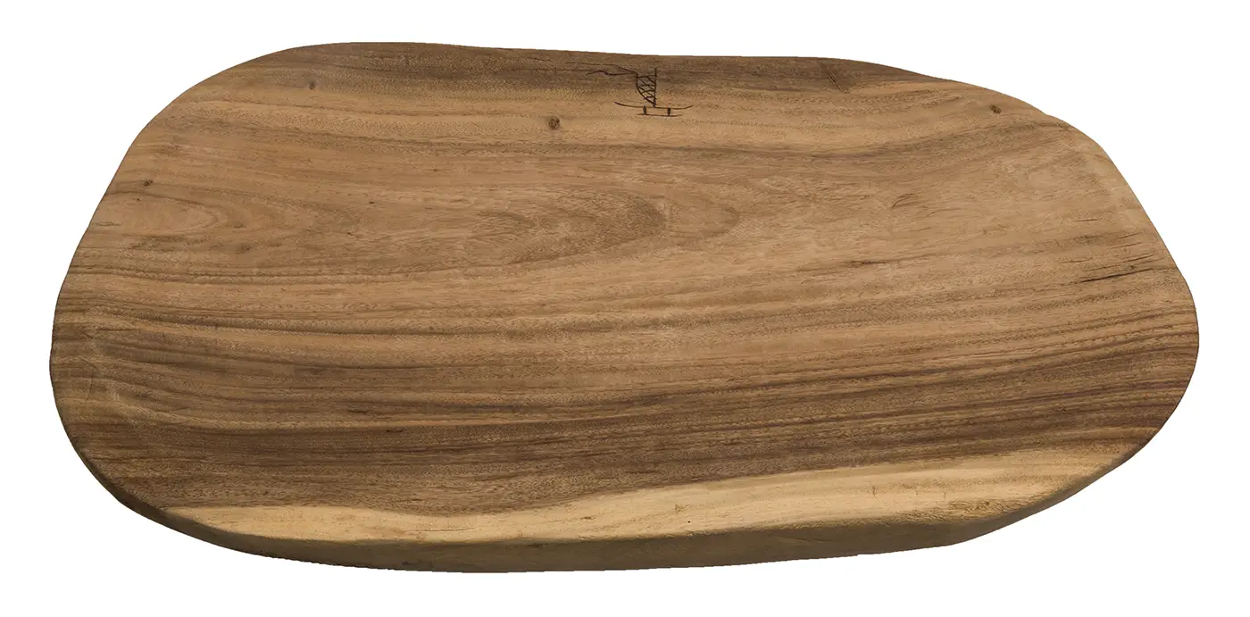 A wooden board with natural grain carved into a rounded rectangle, with slightly convex shape and an etching of a canoe with a sail at the top center. 