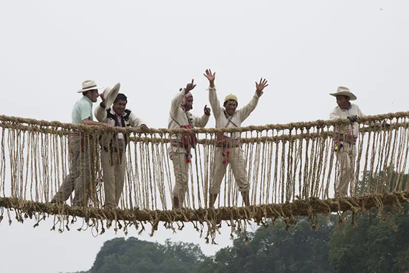 The Quechua builders celebrate completion of the bridge, made in the tradition of the Q’eswachaka bridge in Peru.