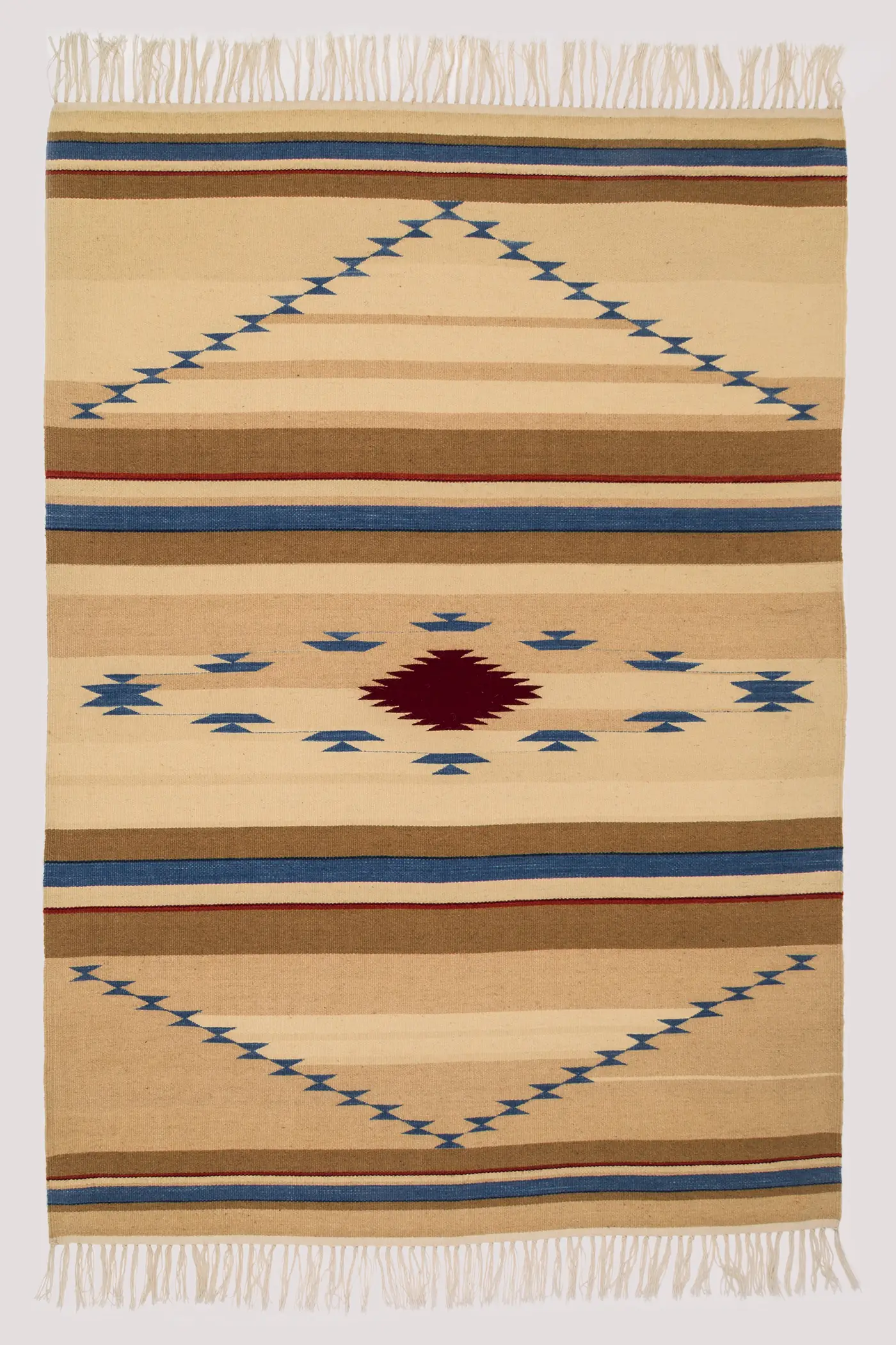 A vertical, rectangular, loom-woven wool rug with horizontal stripes of beige, tan, brown, dark blue, and dark red, featuring geometric patterns in dark blue and red throughout, as well as a row of tassel fringe at both top and bottom. 