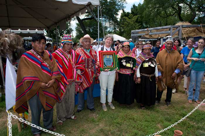 The Kallawaya Festival delegation presents Marjorie Hunt, <i>One World, Many Voices</i> co-curator, with a gift during a blessing ceremony. Photo by Walter Larrimore, Ralph Rinzler Folklife Archives