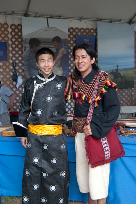 A musician from the Tuvan delegation and a member of Los Masis from Bolivia pose in the <i>One World, Many Voices</i> program area. Photo by Beatrice Ugolini, Ralph Rinzler Folklife Archives