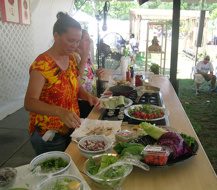 Ilima Ho-Lastimosa and Leinaala Bright demonstrate the preparation of traditional Hawaiian cuisine.