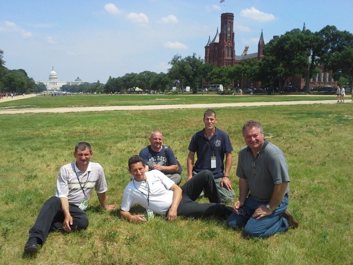 The team building the Dance Barn and Peacock Tower take a break on the National Mall, where these structures will soon emerge.