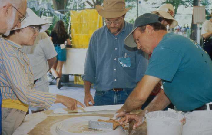 Peter Seitel (center) watches a Festival program demonstration.