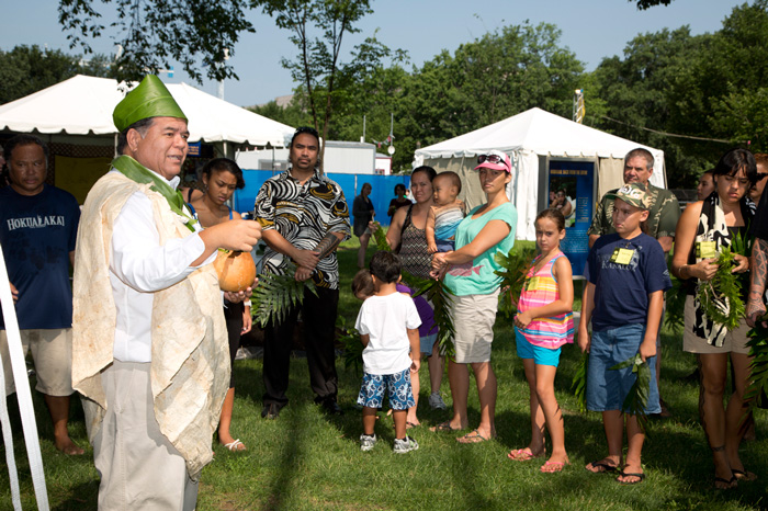 Native Hawaiian community member from <i>One World, Many Voices</i> blesses the program grounds before the Opening Ceremony. Photo by Francisco X. Guerra, Ralph Rinzler Folklife Archives