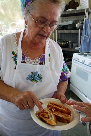 Vera Szarka holding a plate of freshly baked paprika bread. Photo by Lili A. Kocsis