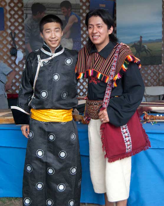 A musician from the Tuvan delegation and a member of Los Masis from Bolivia pose in the <i>One World, Many Voices</i> program area. Photo by Beatrice Ugolini, Ralph Rinzler Folklife Archives