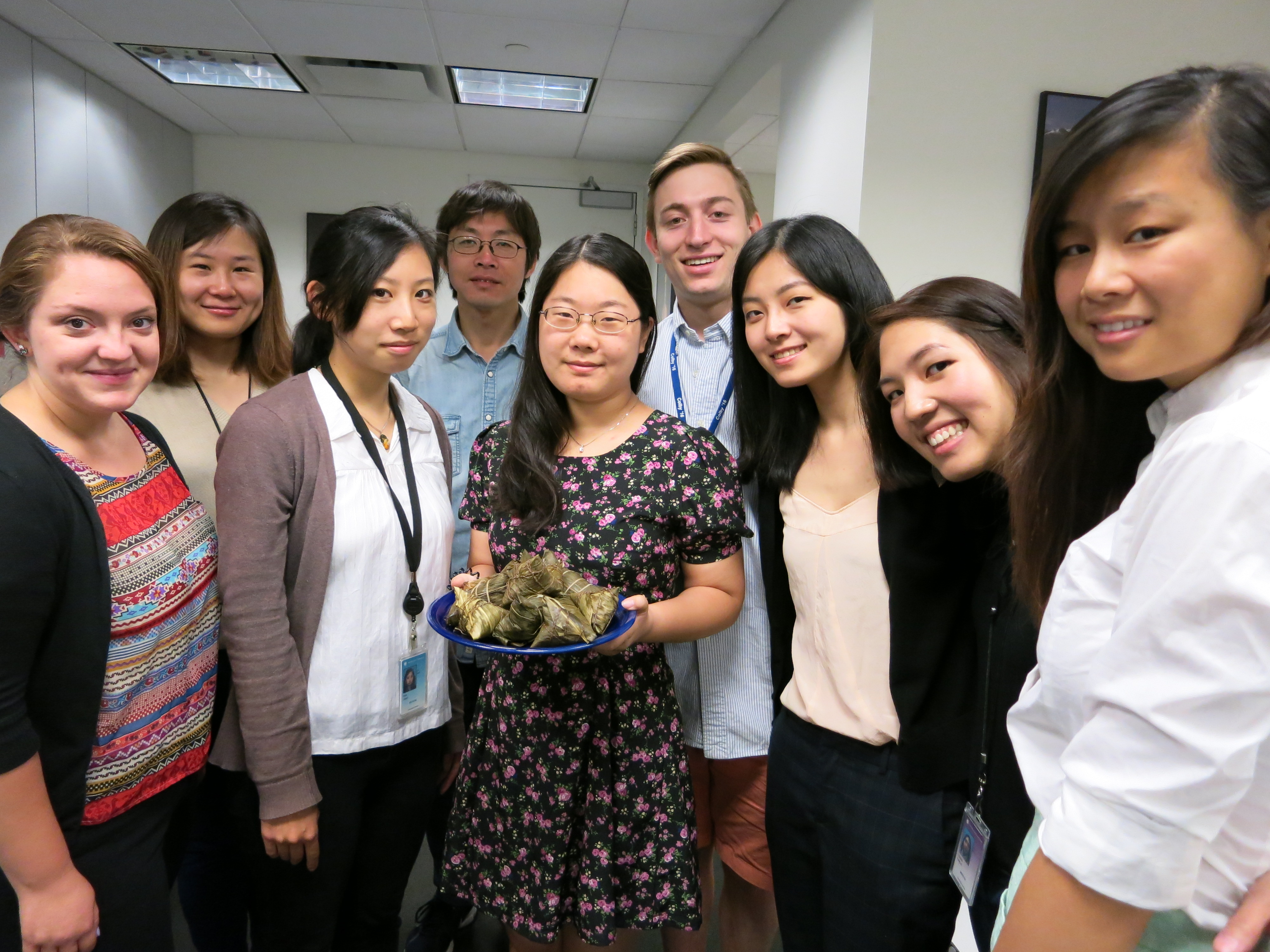 Kenya and China program team members celebrate with a plate of zongzi. L to R: Stephanie Gikkas, Jing Li, Joan Hua, Mu qian, Cindy Xu, Jacob Friedman, Tian Chen, Karlie Leung, and Danielle Wu.