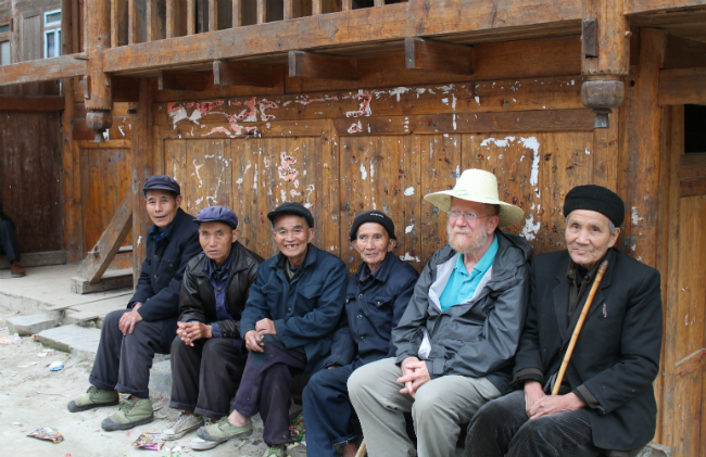 In the Dong village of Dengcen, mature adults hang out together, talk, greet passersby, etc.