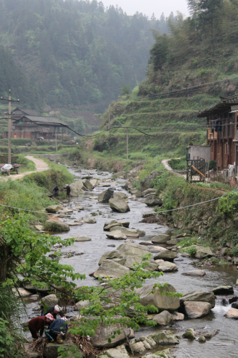 Can you make out if the women by the river are gathering river driftwood for wood stoves or doing their laundry? Photo by Atesh Sonneborn