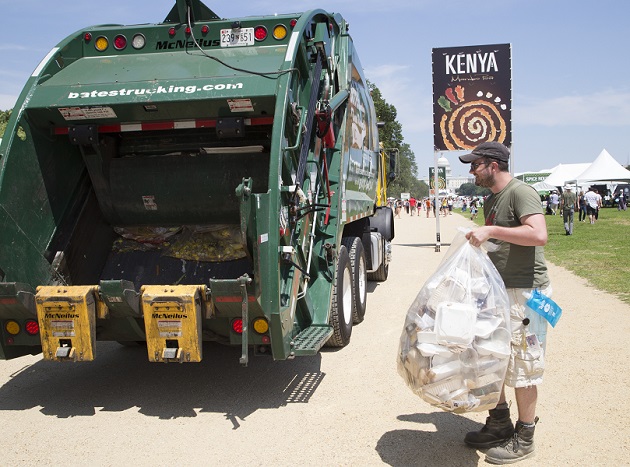 Sustainability intern Ridley Vann hefts a bag of compost into the collection truck. Photo by Hillary Cleary, Ralph Rinzler Folklife Archives and Collections, Smithsonian Institution