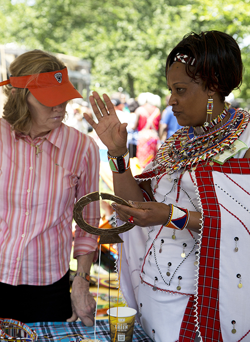 Susan Naserian Nketoria explains her beadwork to a visitor.