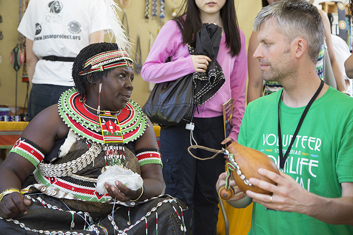 Susana Daniel Chemakwany shares her work with a Folklife Festival volunteer.