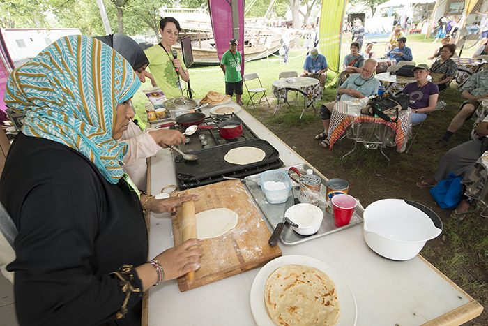 Kenyan chefs prepare chapati in the foodways demonstration tent. Photo by Walter Larrimore, Ralph Rinzler Folklife Archives and Collections, Smithsonian Institution