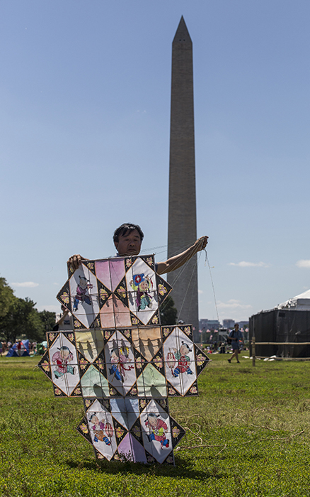 Kite maker Zhang Wenzhi prepares to fly his kite on the National Mall.