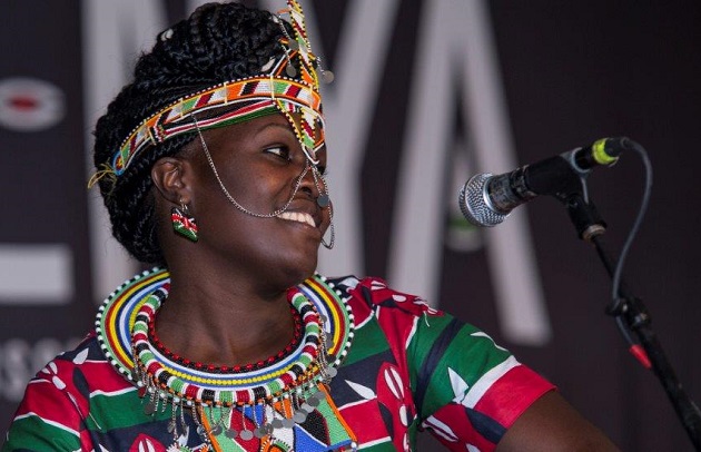 Chepchumba singing and celebrating in her signature style at the Festival Divas Night concert.