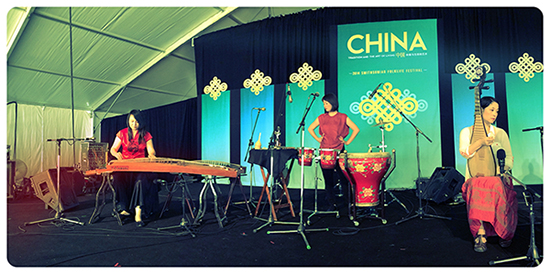 Left to right: Yi Yang (<em>zheng</em>), Haruka Fujii (percussion), and Wu Man (<em>pipa</em>) setting up for the evening concert “Crossroads Asia: Wu Man and Friends.” Photo by KC Commander