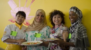 Four very different cooks smiling after a cross-program foodways session on dumplings.