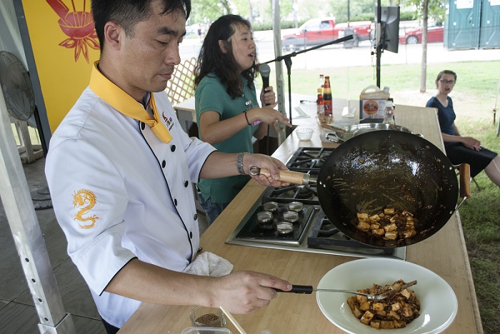 Chef Wang Peng finishing up a bowl of mapo tofu, another recipe he demonstrated at the Festival. Photo by JB Weilepp, Ralph Rinzler Folklife Archives and Collections, Smithsonian Institution