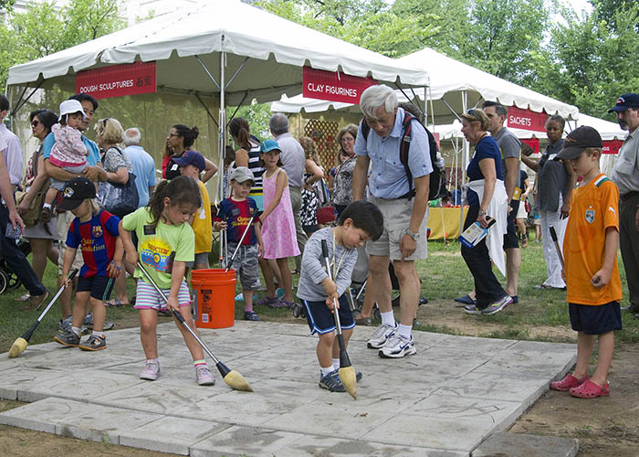 Kids try their hand at water calligraphy in People's Park.