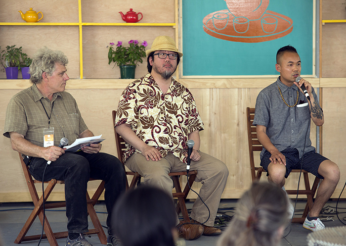 China program co-curator Jim Deutsch, Cedric Yeh, and Adriel Luis in the Teahouse Commons at the 2014 Smithsonian Folklife Festival. Photo by Pruitt Allen, Ralph Rinzler Folklife Archives and Collections, Smithsonian Institution