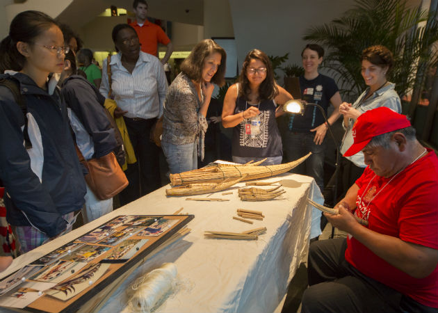 Ángel Piminchumo showed visitors how to weave miniature caballitos de totora. Photo by Francisco Guerra, Ralph Rinzler Folklife Archives