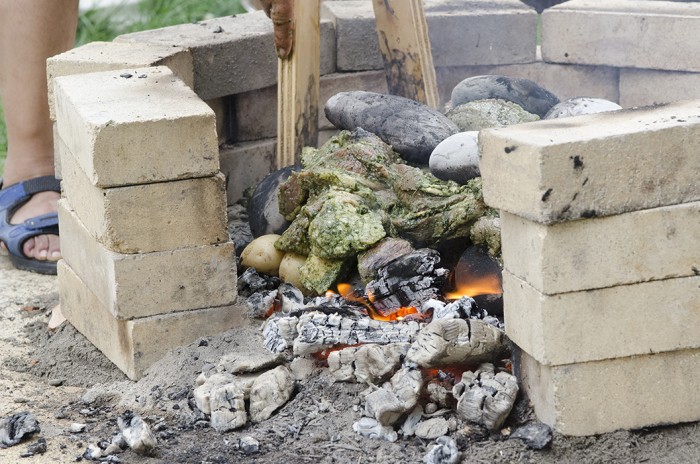 In the pachamanca barbecue pit, MONKY cooked meet straight on the hot stones. Photo by Josh Weilepp, Ralph Rinzler Folklife Archives