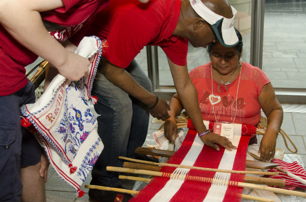 Visitors who are blind or have low vision participated in a tactile tour, meeting weavers and embroiderers and learning about their art. Photo by Josh Weilepp, Ralph Rinzler Folklife Archives