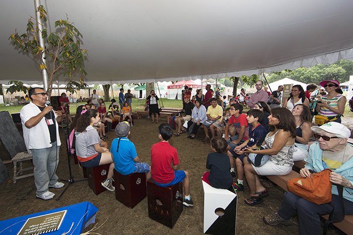 Alex Acuña returned to teach children how to play the cajón in the Wawawasi Kids Corner. Photo by Micheal Barnes, Ralph Rinzler Folklife Archives