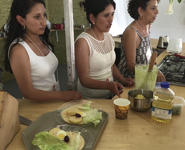 Carved gourd artists Blanca and Katya Canto Lazo made papa a la huancaína in El Fogón Kitchen. Photo by Erin Kurvers, Ralph Rinzler Folklife Archives