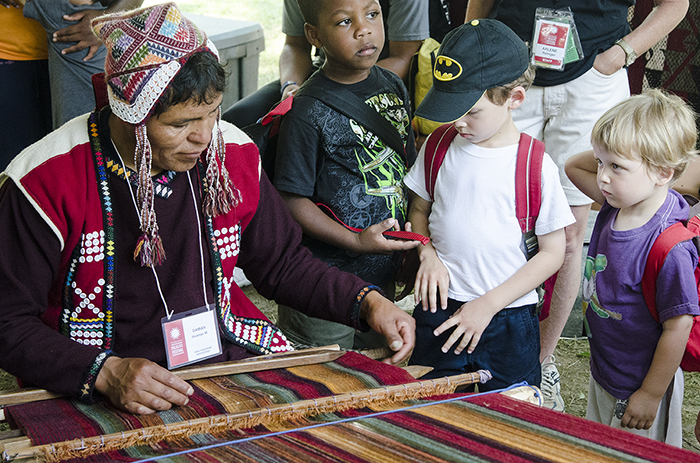 Damien Huaman of the Centro de Textiles Tradicionales del Cusco demonstrated weaving techniques on a backstrap loom. Photo by Josh Weilepp, Ralph Rinzler Folklife Archives