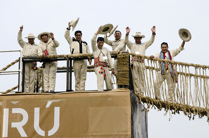 The Q'eswachaka Bridge builders waved from their completed structure. They stayed an extra day to disassemble the bridge; half with go into the National Museum of the American Indian in D.C., and the other half to the museum's location in New York City. Photo by Josh Weilepp, Ralph Rinzler Folklife Archives