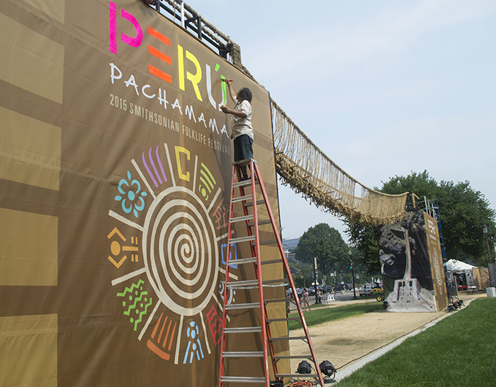 MONKY got permission to "chicha-ize" the bridge banner. Photo by Sarah Bluestein, Ralph Rinzler Folklife Archives