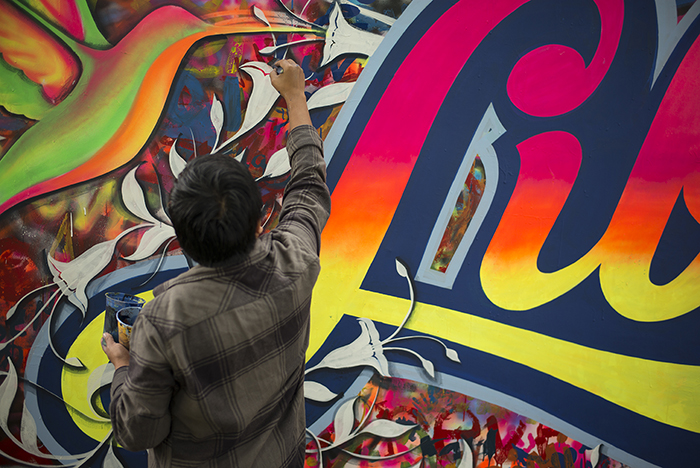 Urban artist Eliot Tupac continued work on the Liberabit (“Freedom”) mural. Photo by Vivianne Peckham, Ralph Rinzler Folklife Archives