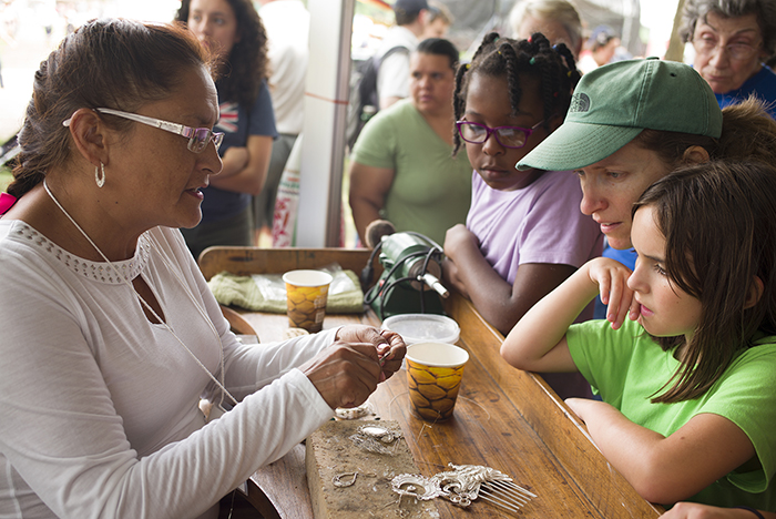 Eda Arroyo demonstrated to young visitors how she makes silver filigree jewelry for Marinera dancers. Photo by Vivianne Peckham, Ralph Rinzler Folklife Archives