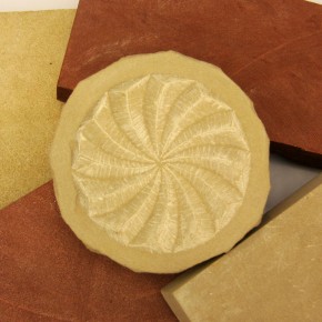 Bernat's beige stone from Basque Country and the Smithsonian's red stone from Maryland, with a carving by Bernat in the middle. Photo by Elisa Hough