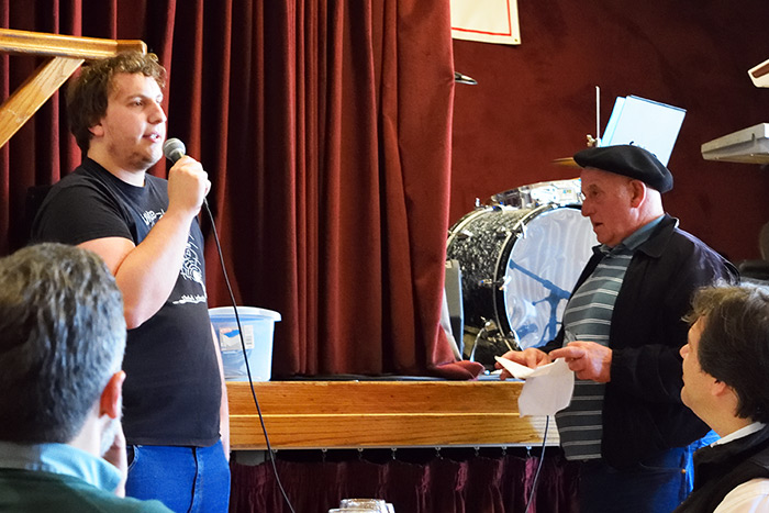 A young bertsolari-in-training challenges expert Johnny Curutchet to a verbal duel at the San Francisco Basque Cultural Center. Photo by Greyson Harris, Ralph Rinzler Folklife Archives