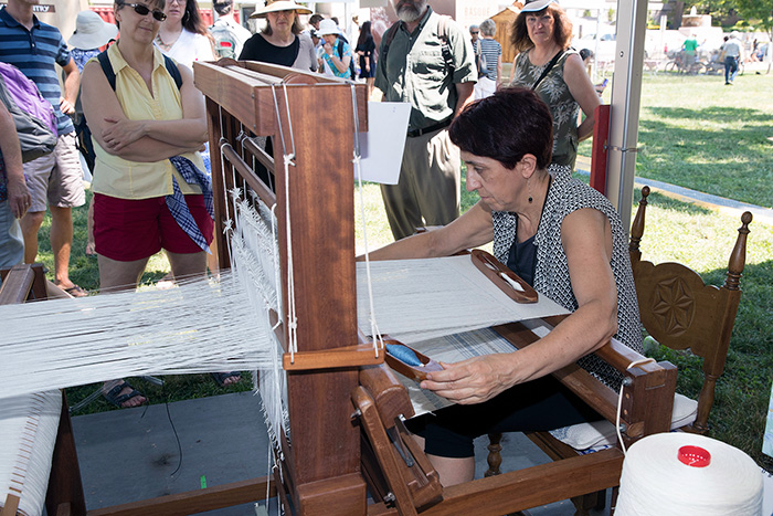 Olga Uribe Salaberria worked away on her loom, creating fine textiles. With her engineering background, she analyzed old cloths and restored an antique loom, leading a revival of this textile tradition. Photo by Francisco Guerra, Ralph Rinzler Folklife Archives