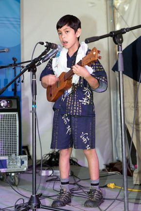 During the "Fandango Son Jarocho" performance on the Sounds of California Stage & Plaza, Quetzal and Martha Gonzalez's son, Sandino, joined them on the <em>jarana</em>. Photo by Francisco Guerra, Ralph Rinzler Folklife Archives