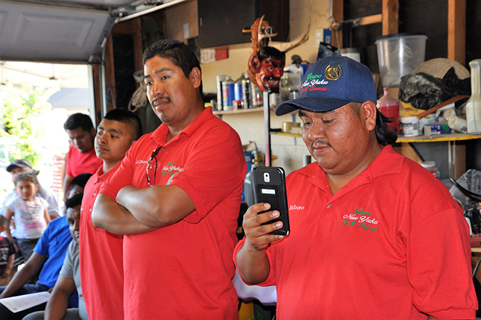 Diego Solano of Grupo Nuu Yuku/Danza de los Diablos de San Miguel Cuevas records a presentation about the preparations for the Smithsonian Folklife Festival to share on social media. Photo by Amy Kitchener, courtesy of the Alliance for California Traditional Arts