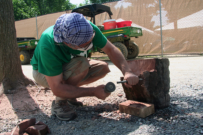 Behind the scenes, stone worker Bernat Vidal prepared a stone leftover from the construction of the Smithsonian Castle. Over the next few days, Bernat will carve a piece that will stay in Washington, D.C. Photo by Elisa Hough, Ralph Rinzler Folklife Archives