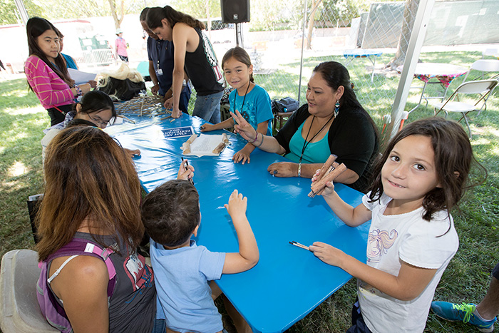 Throughout the day, Stan and Marta Rodriguez taught young visitors how to play Native Kumeyaay games. No luck? "Kunmuk," Stan would say. "Let it go." Photo by Francisco Guerra, Ralph Rinzler Folklife Archives