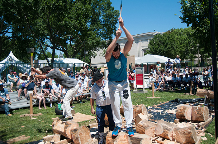 This weekend only, a few Basque athletes are competing at wood chopping, known as aizkolaritza. The fastest to chop their log in two with ax swings between their legs is the victor. Photo by Joe Furgal, Ralph Rinzler Folklife Archives